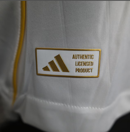 Close-up of the Adidas label reading 'Authentic Licensed Product' on a white jersey.